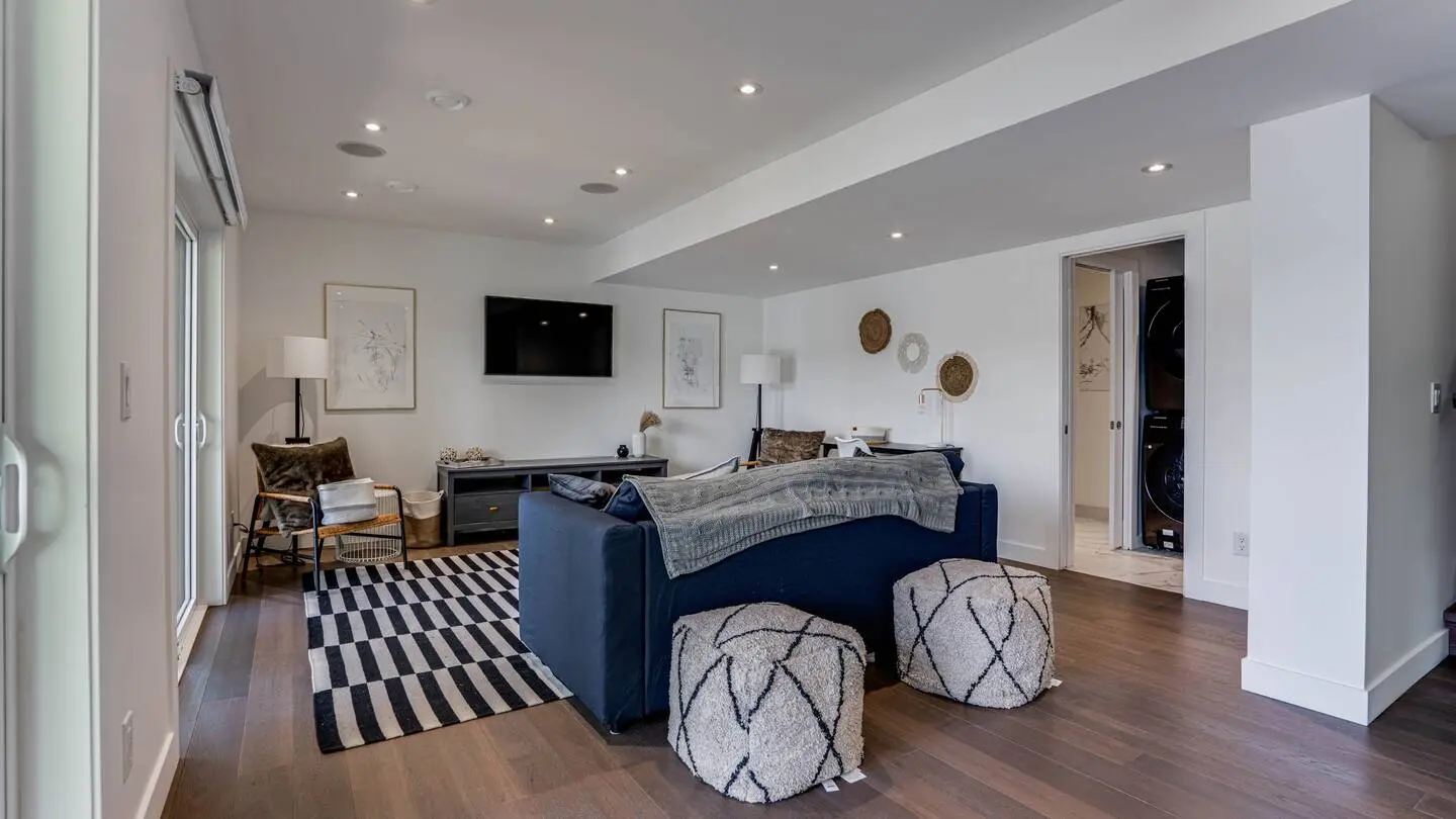 Lower-level family room with sofa and TV