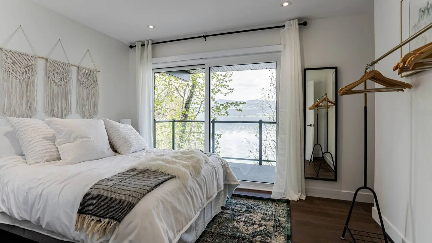 Bedroom with lake view and clothes rack
