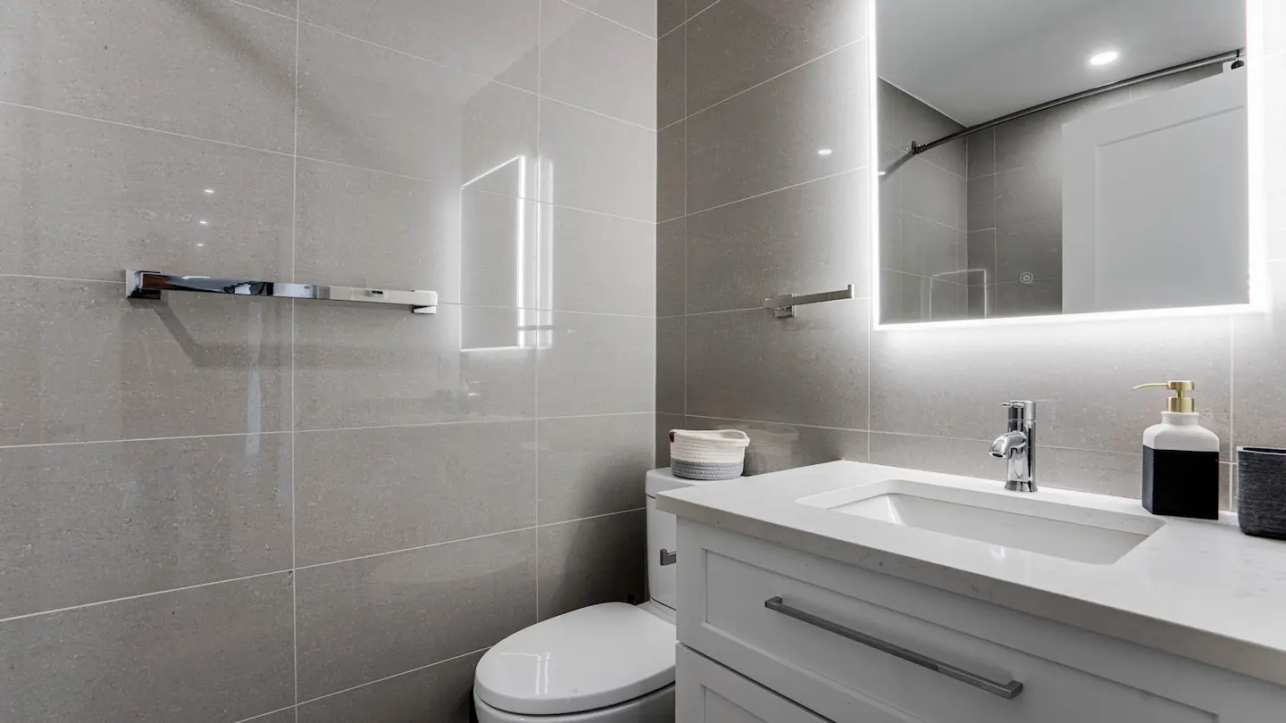 Bathroom with backlit mirror